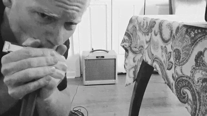 How do a mic and amp change the sound of a harmonica?